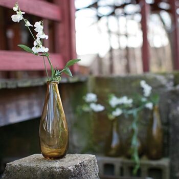 artisan bottle clear brown round vessel glass flowers rental