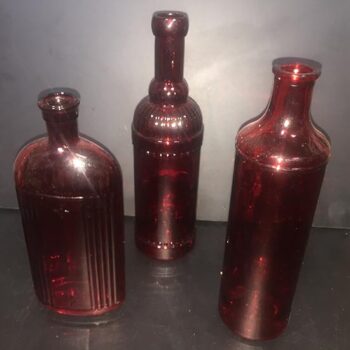 vintage bottle red clear bottle vessel flowers rental